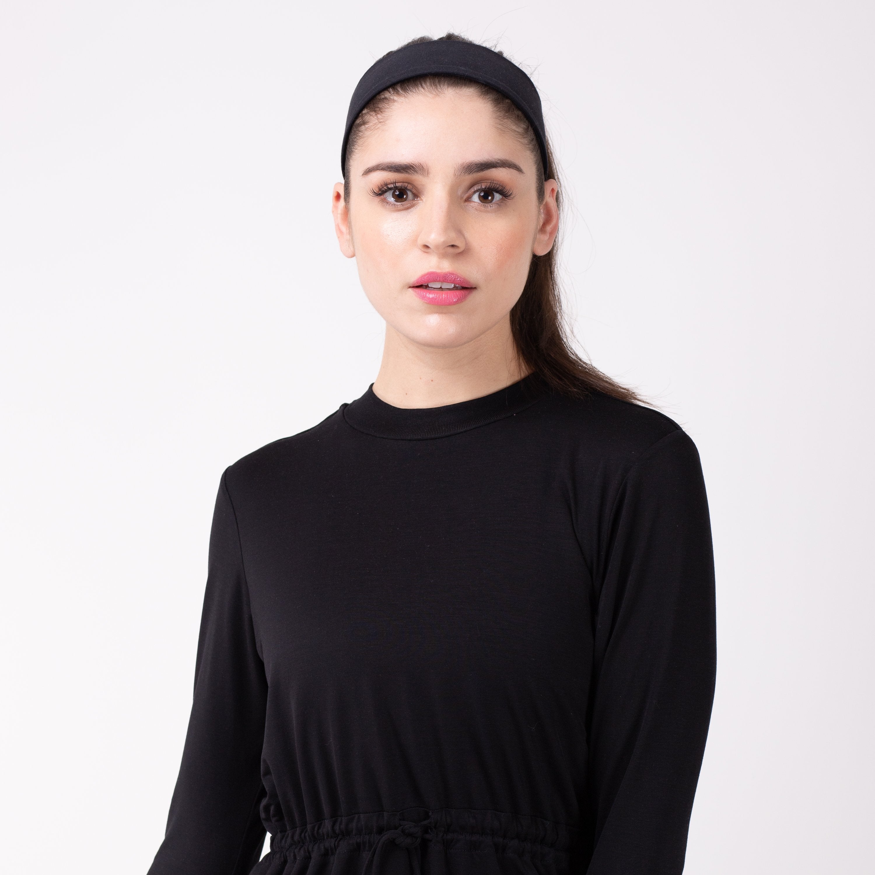 Woman in black shirt with matching black HAWA headband.