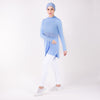 Woman in sky blue HAWA Step Tee with right arm crossed over her body and left leg popped.